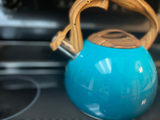 Tea pot steaming from stove